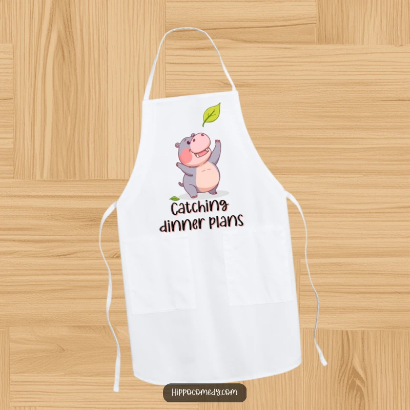 Funny apron with a determined hippopotamus humorously trying to catch a falling leaf, perfect for kitchen use.