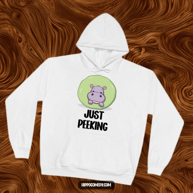 Funny Hoodie: A curious hippopotamus playfully peeks out from behind a giant, round lily pad, inviting discovery.