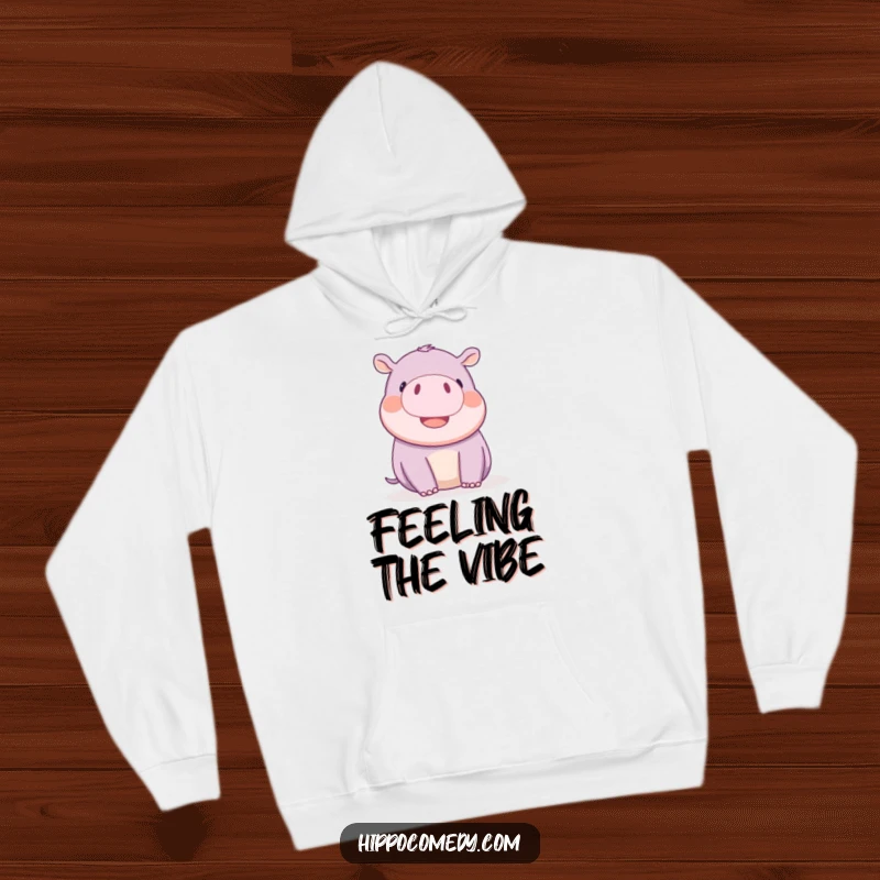 Funny kawaii hippopotamus playfully wiggling its tiny ears with delight, on a soft, warm hoodie.