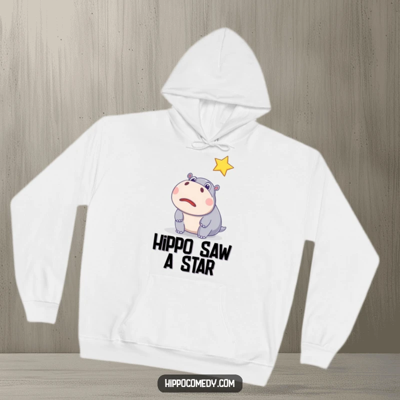 Funny hoodie featuring a surprised hippo with wide eyes watching a sparkling star, offering cozy comfort and hilarious magical vibes.