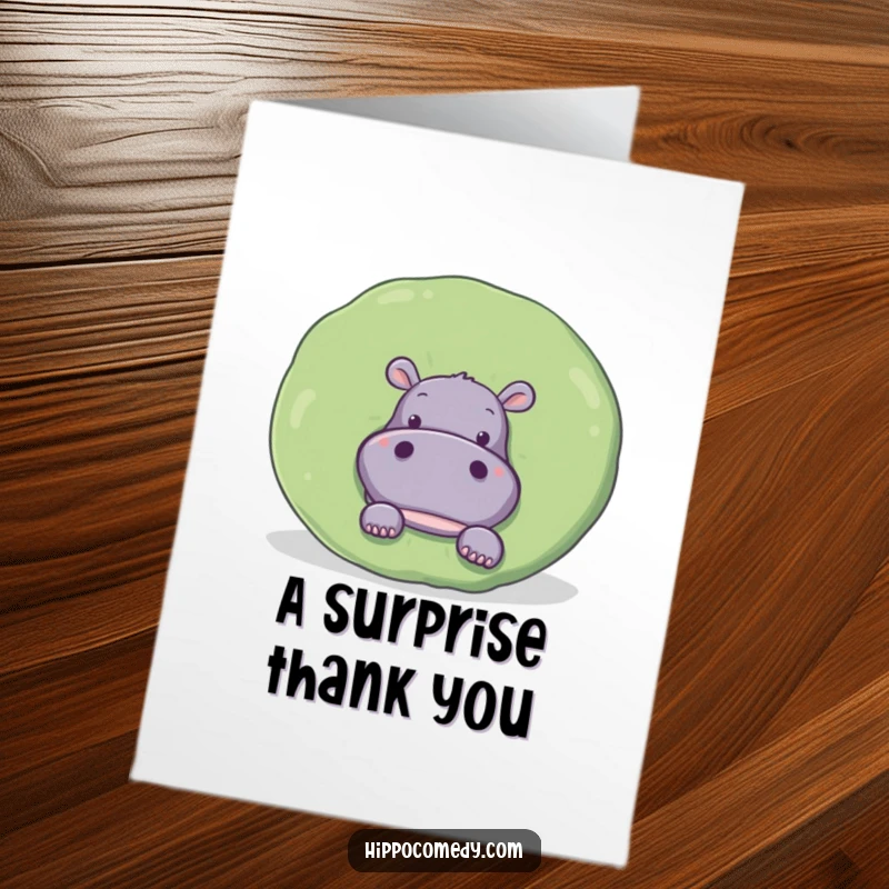 Funny Free Printable Thank You Card: A curious hippo peeks out from behind a large, round lily pad, conveying thanks.