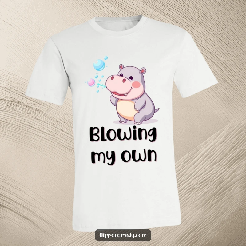 Funny T-Shirt: A playful hippopotamus is captured mid-action, blowing a stream of shimmering rainbow bubbles.