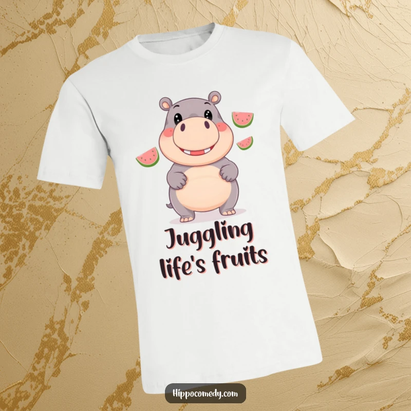 Funny T-Shirt: A giggling hippopotamus with beaming eyes is shown juggling three bright, shiny watermelons.