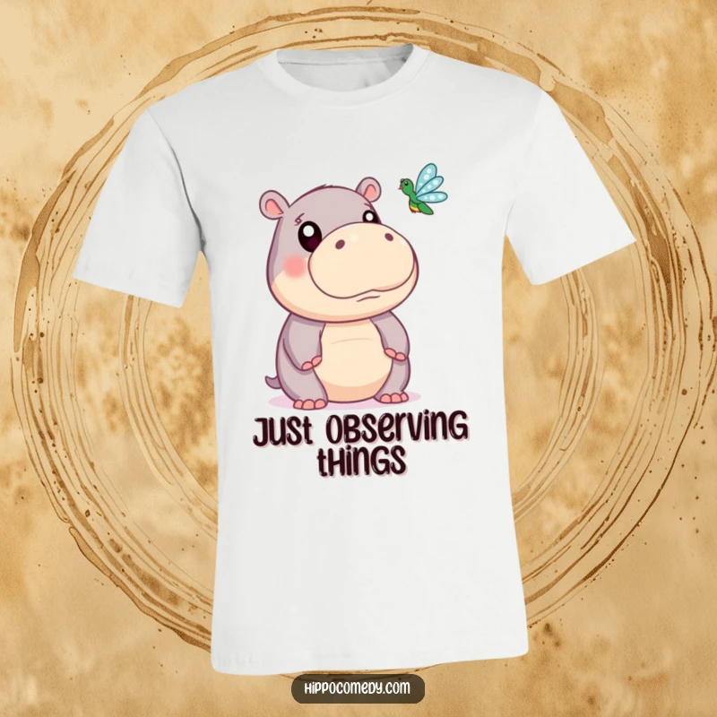Funny t-shirt with a cute hippopotamus character, its wide eyes fixated on a beautiful dragonfly fluttering nearby.