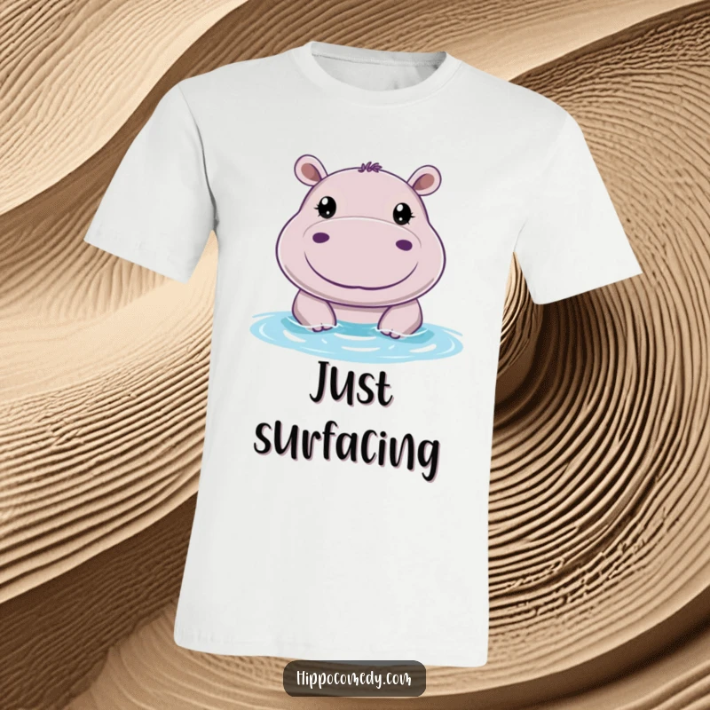 Funny t-shirt graphic of a cheerful hippo with big, round eyes, peeking playfully above the water with a happy expression.