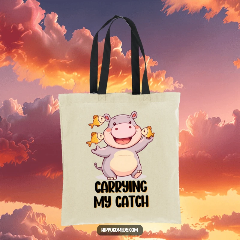 Funny happy hippo tote bag showing a smiling hippopotamus juggling three small fish, ready to carry your items with aquatic charm.