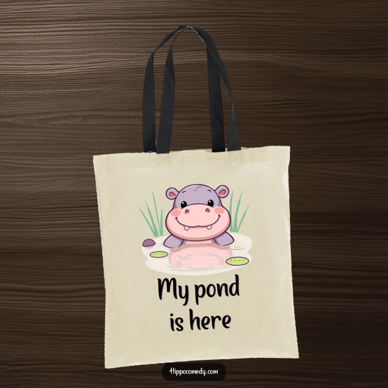 Funny kawaii hippo tote bag with a cute hippo peeking from a pond, displaying a wide, joyful smile.